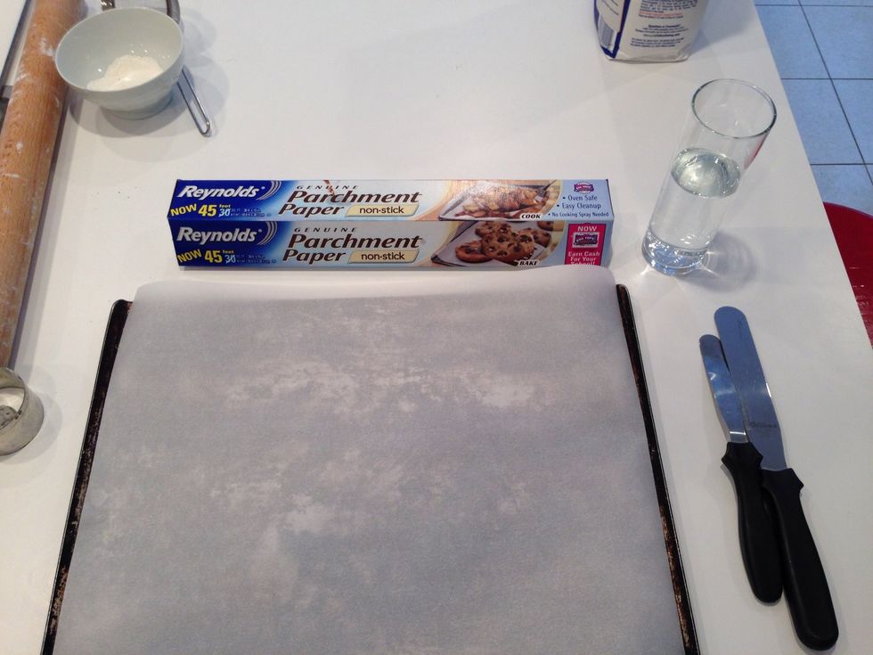 Get out your cookie sheets and cover them with parchment. This will allow the cookies to slide off the sheet onto the counter. Oddly, it doesn't keep the sheets clean. There will be grease.