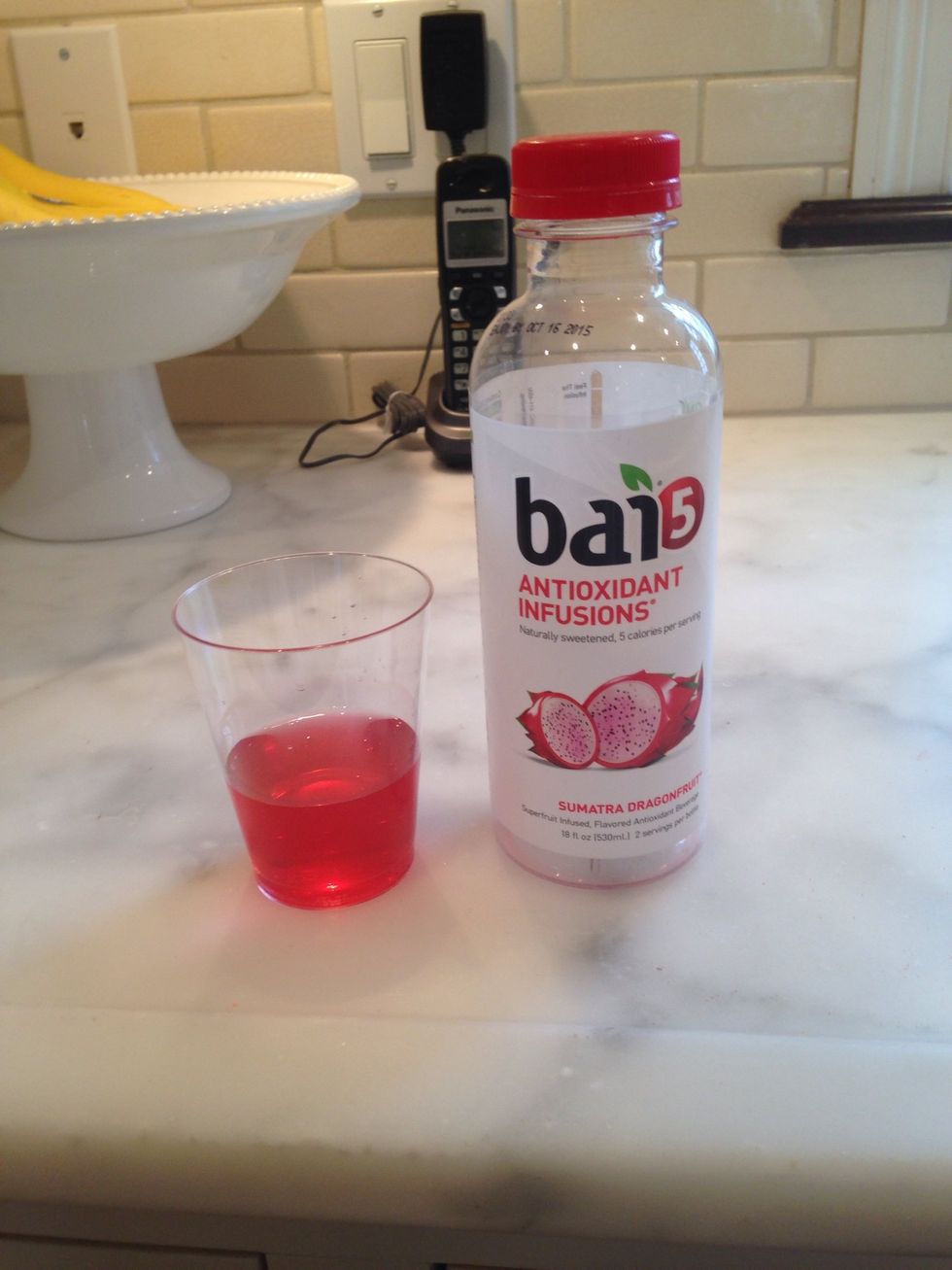 Get out your favorite drink. I like to use bai 5 Sumatra dragon fruit but you can use any drink from water to lemonade to ginger ale. Then fill the cup up with your drink until it is about half full