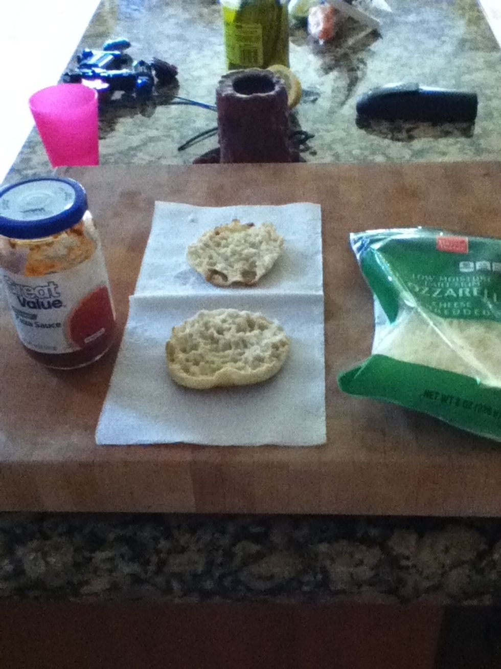 Get out your ingredients: Pizza sauce, shredded cheese, and an English muffin.