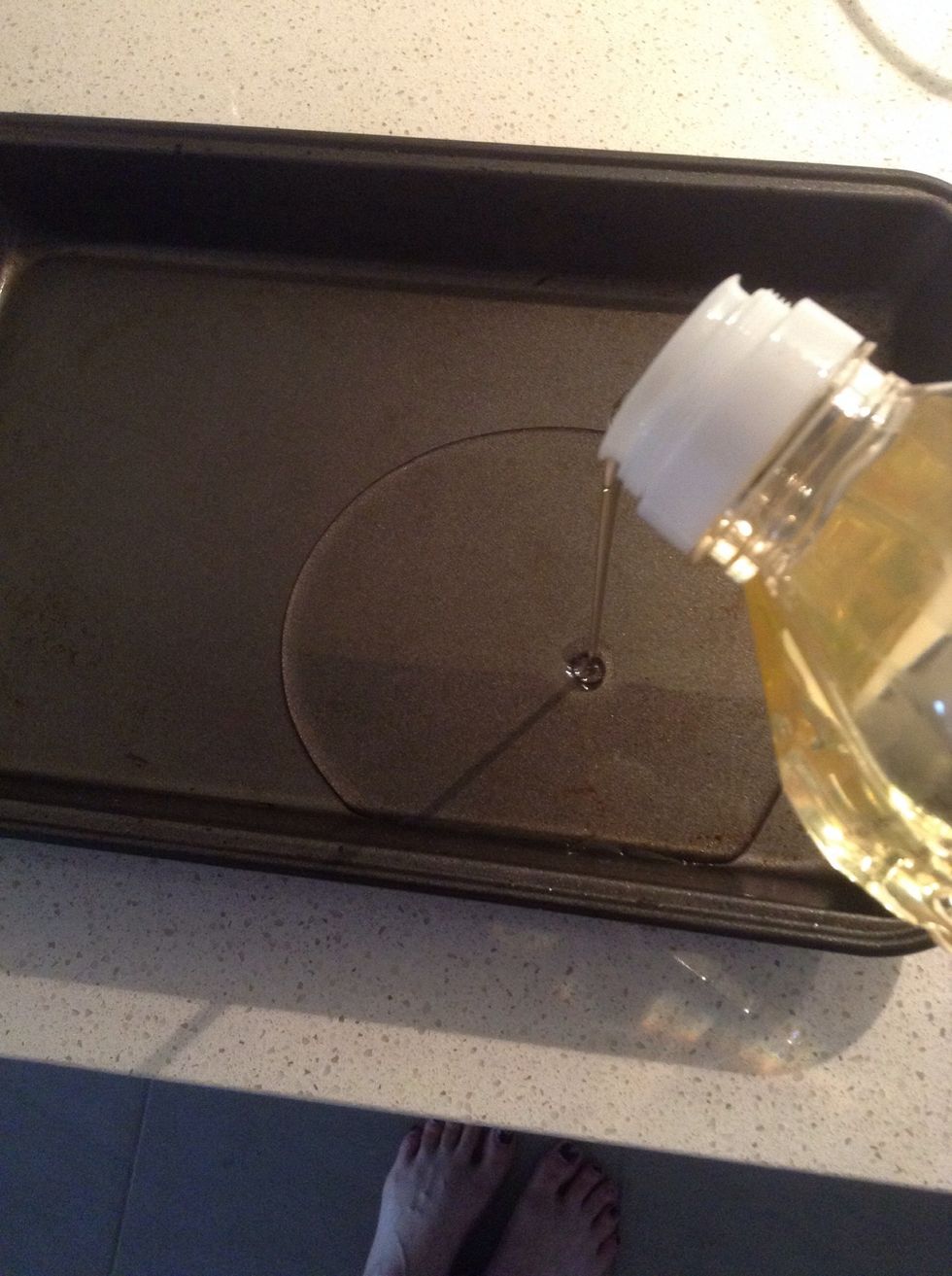 Get out your tray and put a good amount of oil in, enough to fill the whole tray with a thin..ish.. Layer of oil. Don't hold back too much! (You can use goose fat if you want but I'm vegetarian)