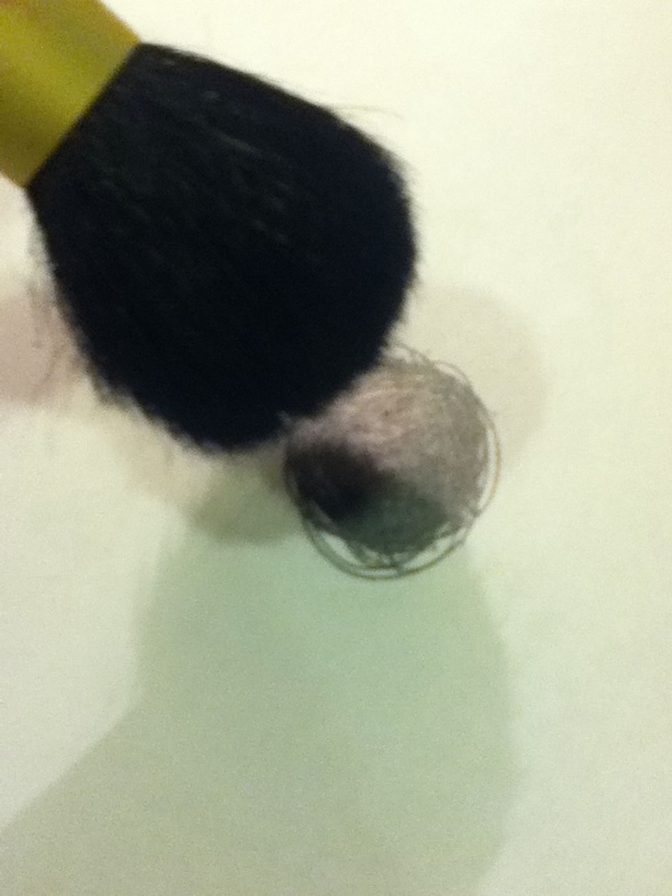 Get some powder lead or draw a patch of it and take a fluffy brush and coat your eye in a few layers if it.