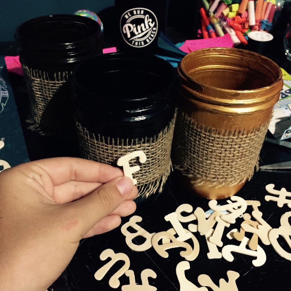 Get some wooden cool letters and hot glue them to the fabric