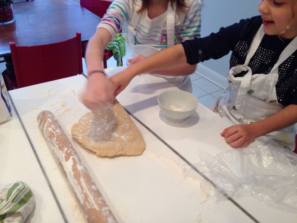 Get the dough out of the fridge 1/2 hr. Before you start. Put it on counter and dust with flour. Use plenty, so the rolling pin doesn't stick. Turn the oven up to 350.
