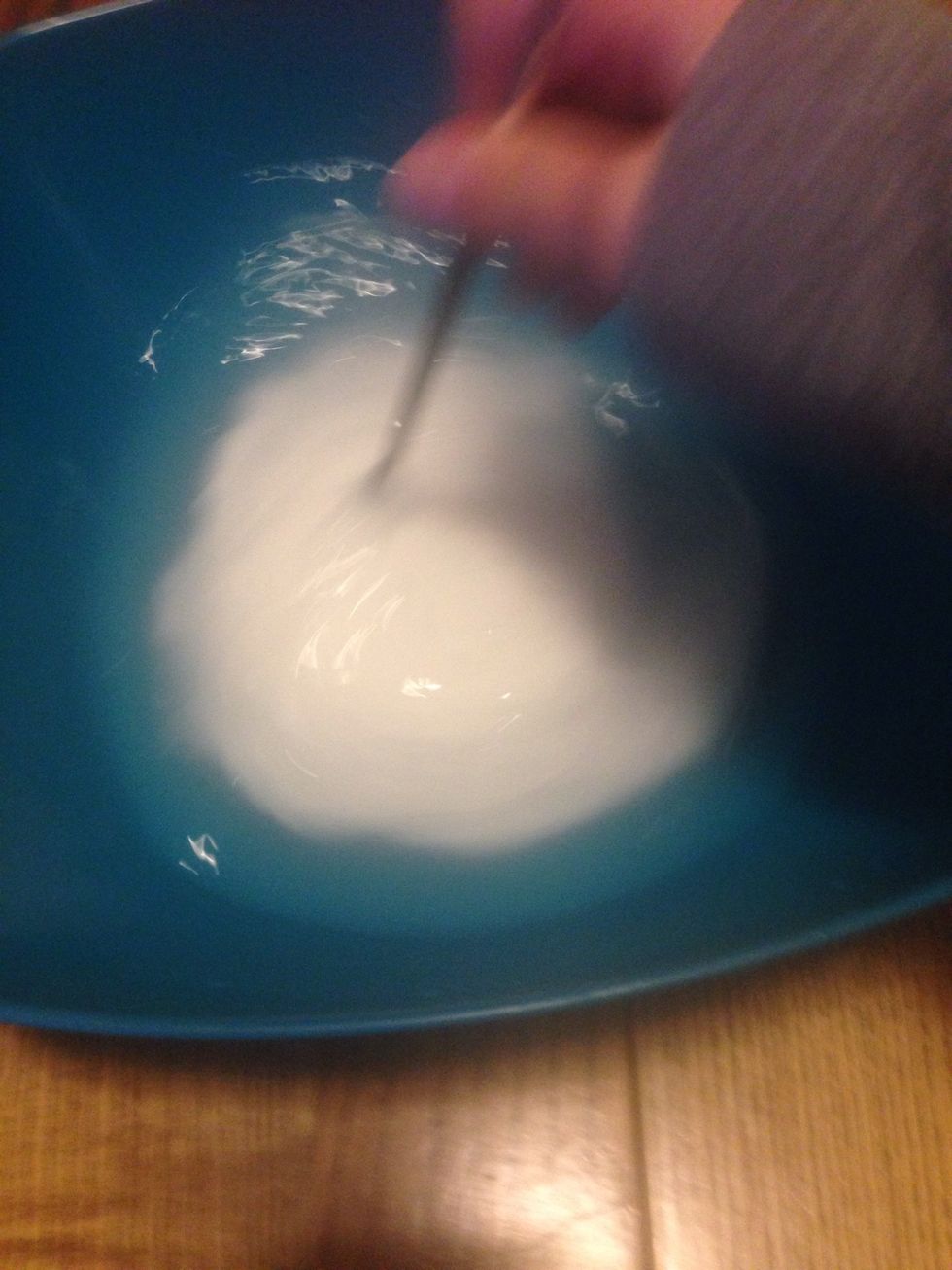 Get the end of your paintbrush and mix the two solutions together