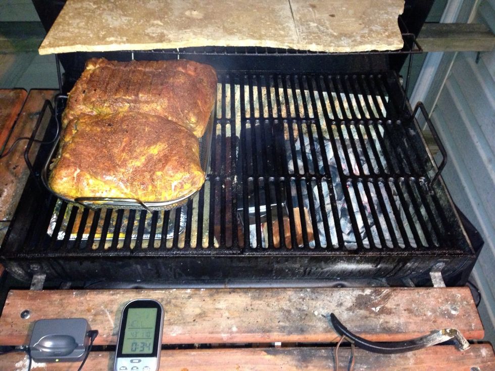 Get the grill to around 225 and place a drip pan beneath the meat. Add wood that you want to use. Hickory, cherry and apple wood are all great choices.