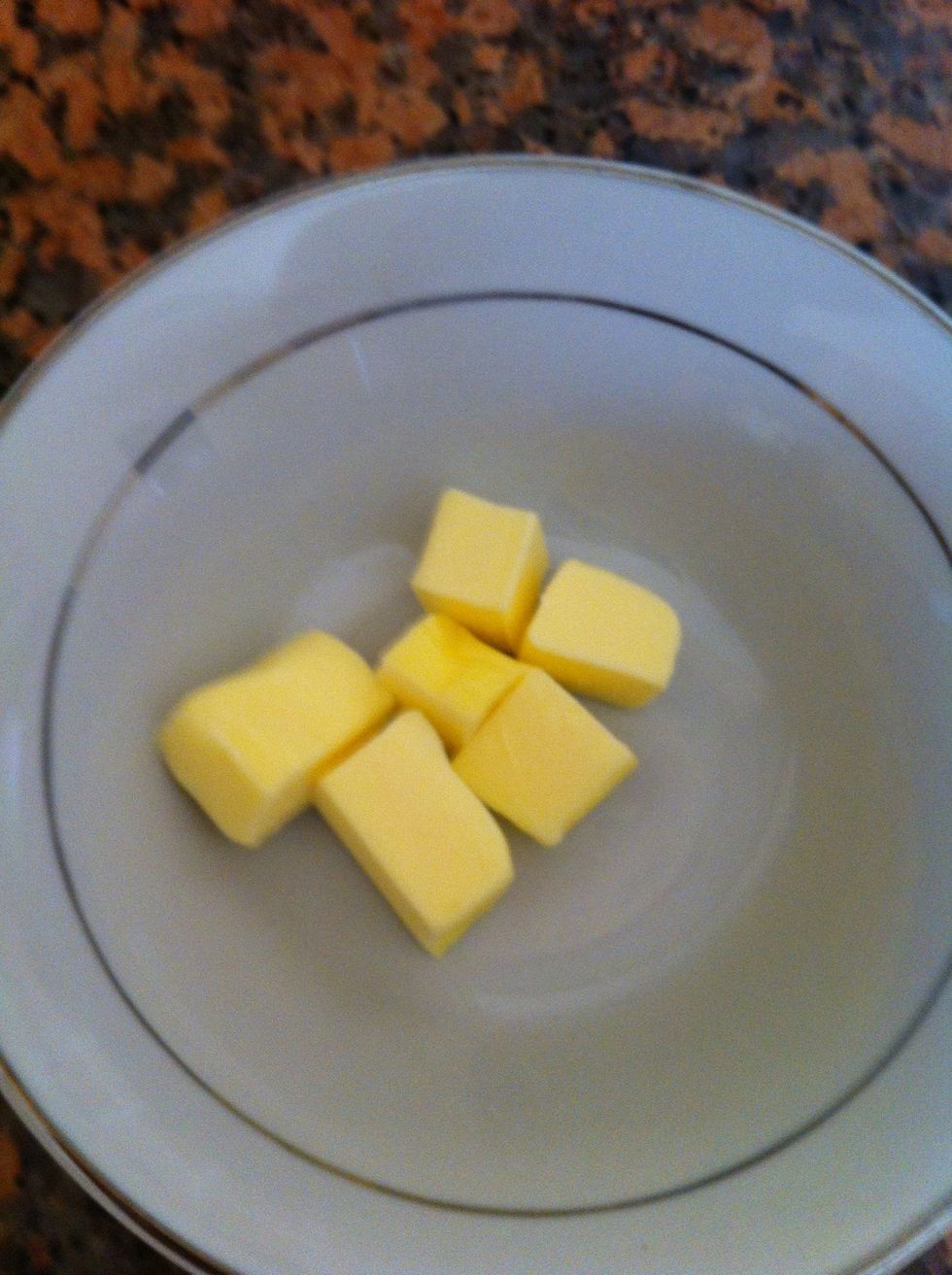 Get the hard cubed butter and add it on the flour