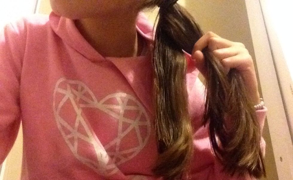 Get the left piece of hair and turn it over the other two.