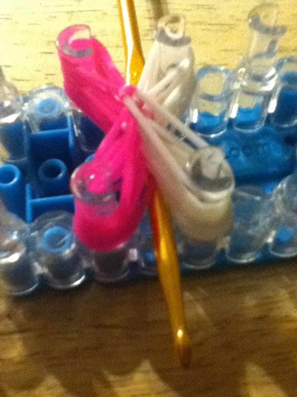 Get the loom hook and take it under a side.