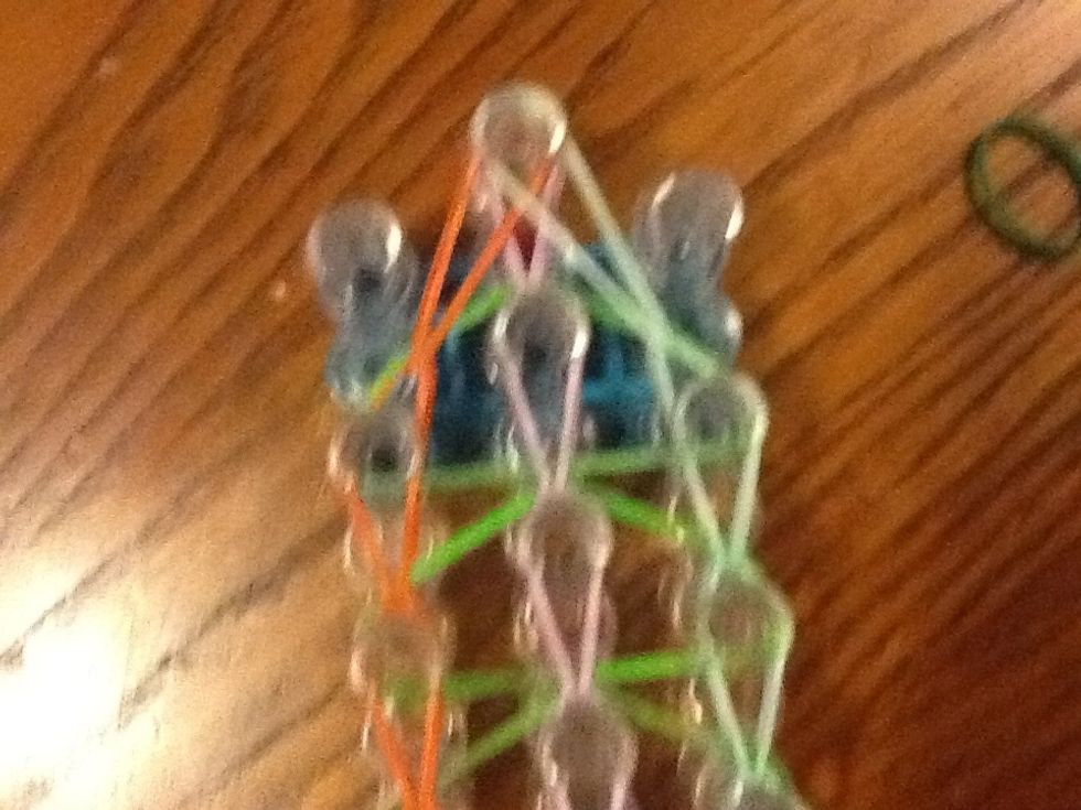 Get the orange and put it on top and do it with the other side as well