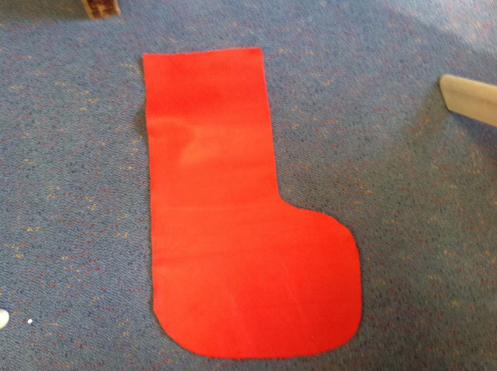 Get the red felt and cut out a stocking shape. Choose the size you want.