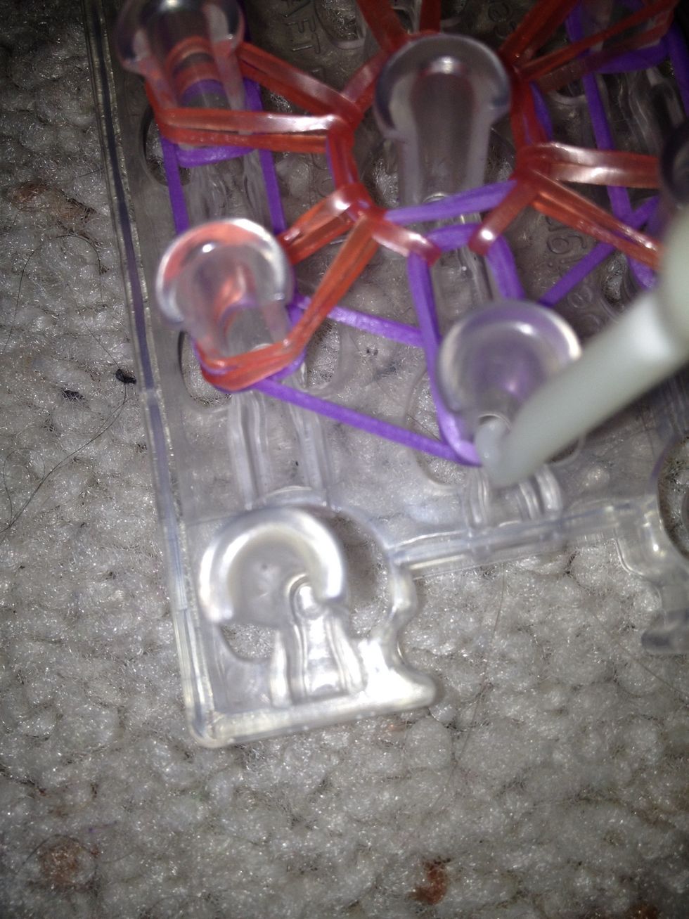 Get the second to last band and pull it to the peg on the left side across from it