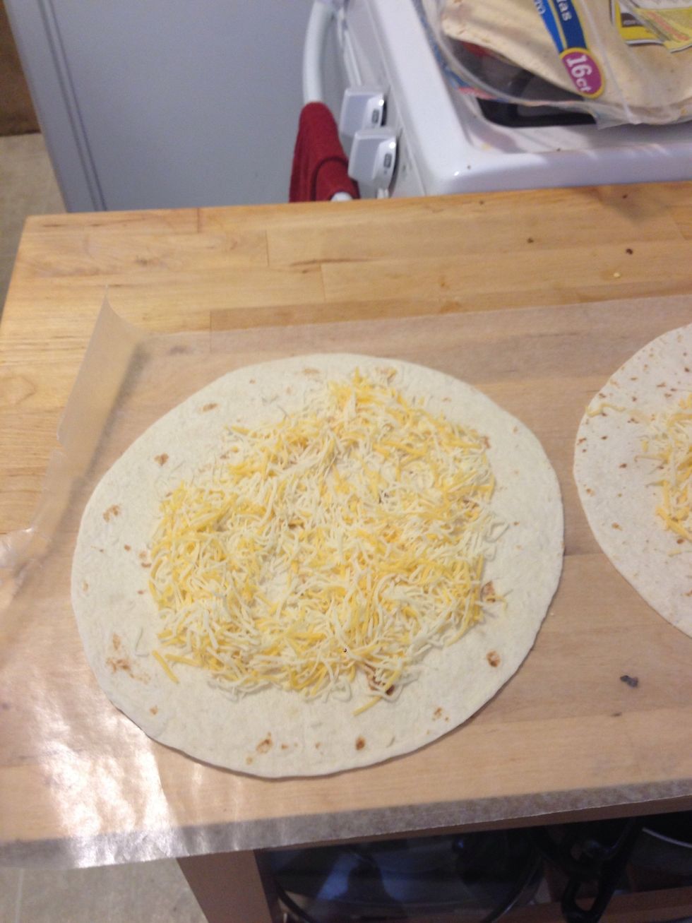 Get the tortilla out and layer with sauce(if desired). Salsa would have tasted good on this. Add desired amount of cheese on top.