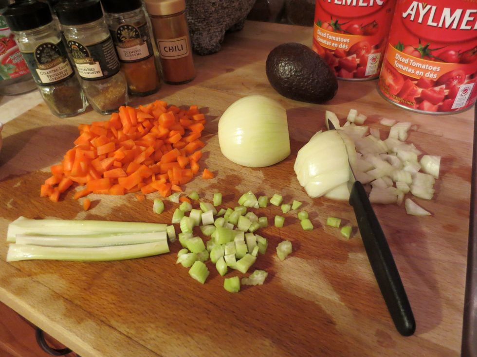 Get the two med/large pots out. Clean and dice the carrot and celery. (save leafy tops for broth) cut the ends off your onion, remove paper, dice the onion.