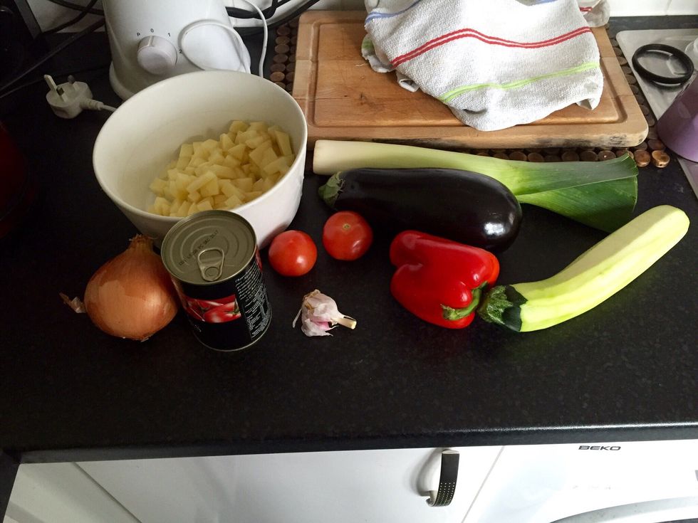 Get things ready. Chop the potatoes, courgette and eggplant in small cubes.