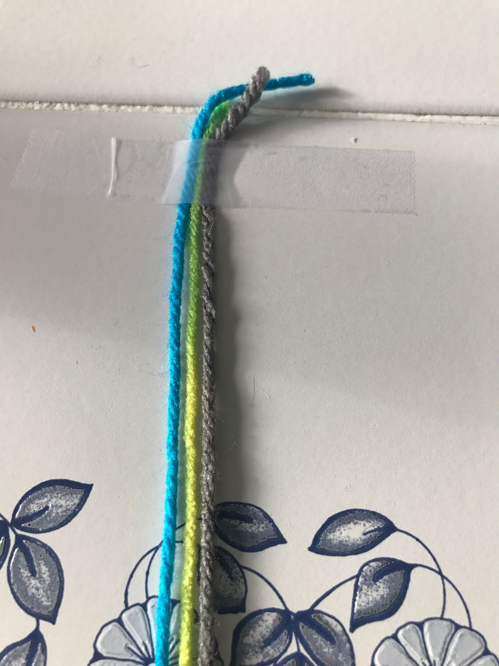 Get three 20" strands of yarn, I'm using yarn from jo Ann's fabric as craft store