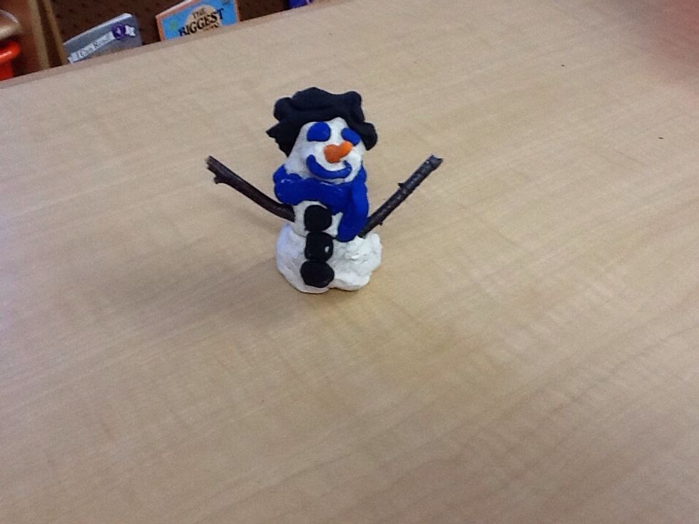 Get two tiny sticks from outside then put it into the snowman's body.
