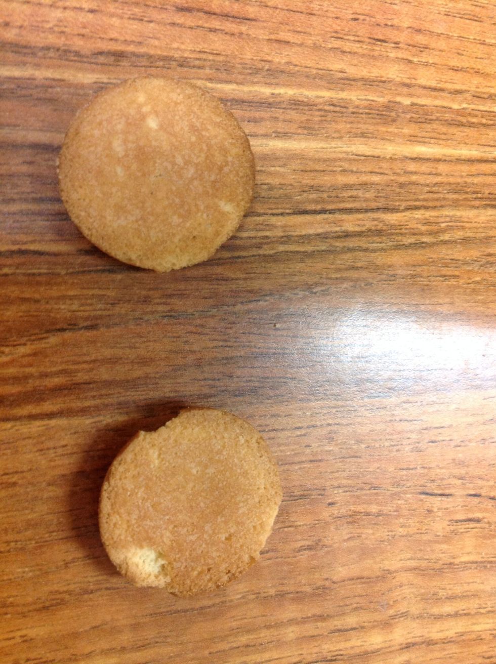 Get two vanilla wafers (To look like buns)