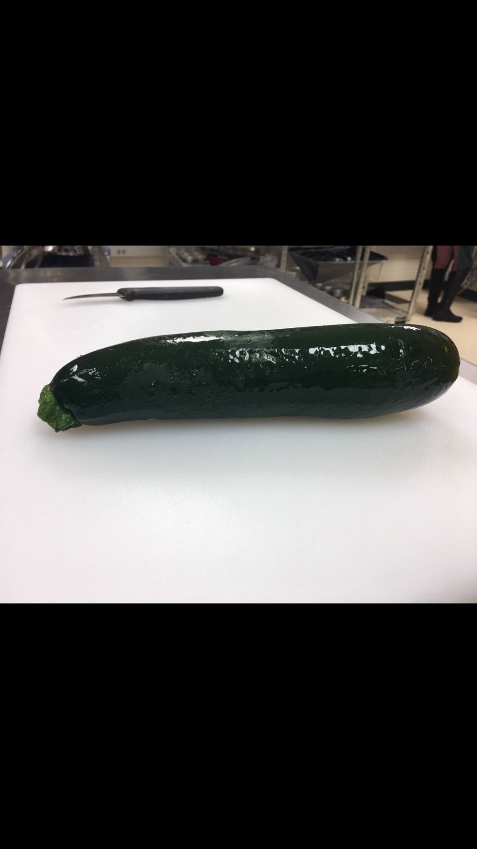 Get you a Zucchini, rinse it and place on cutting board.