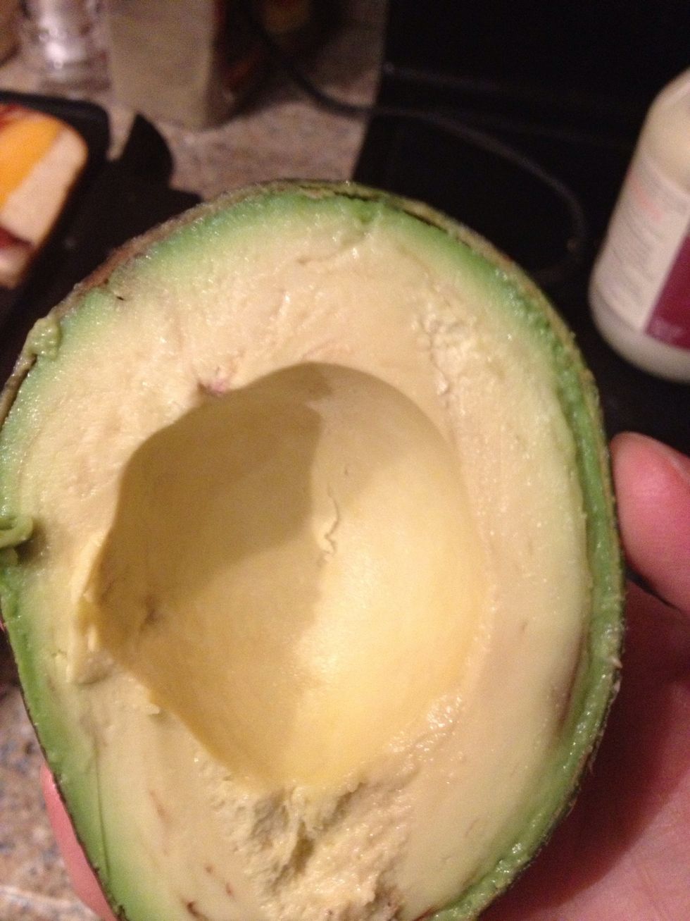 Get your avocados, you know you want to, and slice them lengthwise. The scoop them out and distribute....