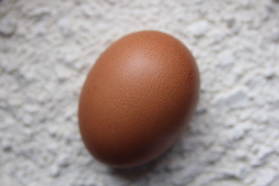 Get your egg and flour out. Weigh 250g of self raising flour into a mixing bowl. Crack the egg into the wet ingredients and mix in.