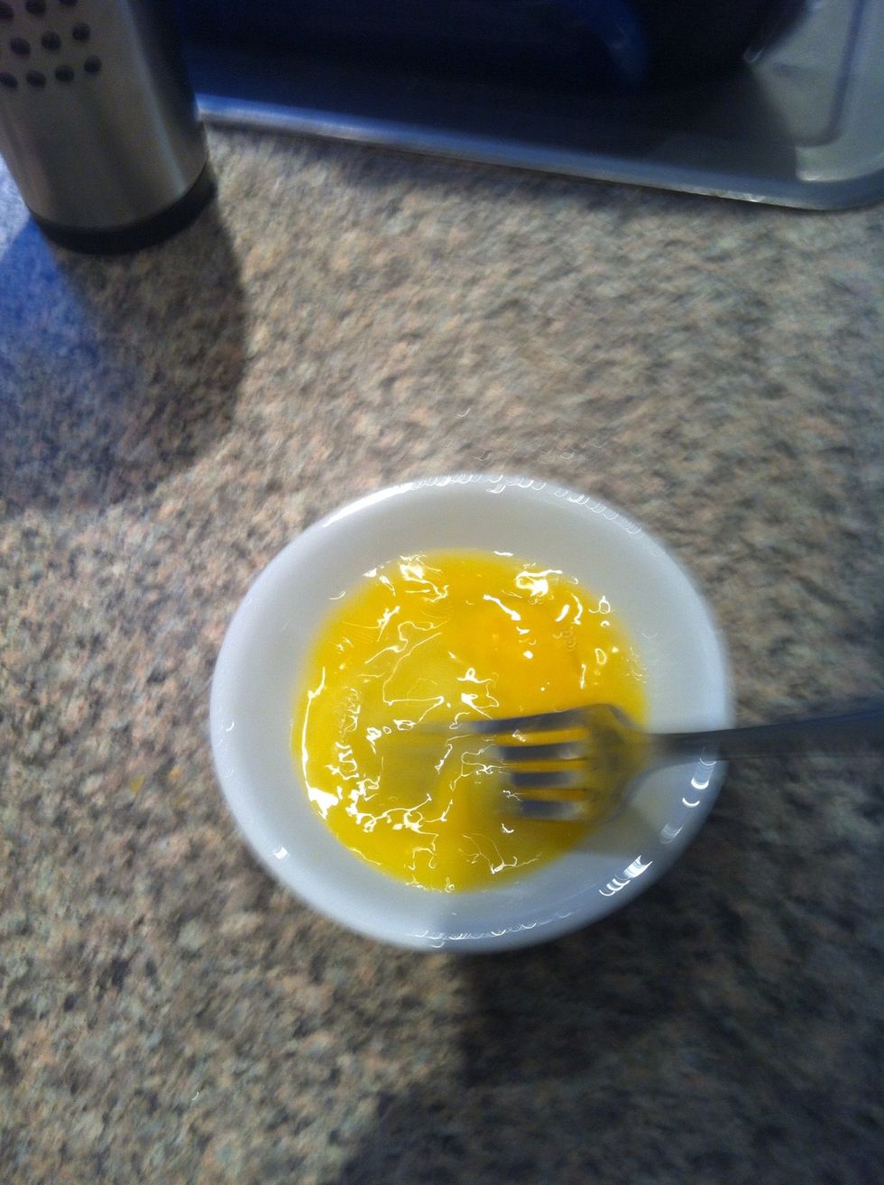 Get your egg and scramble it well with a fork. Scrambling is the key here. Too little scrambling and you might hear a large bang in your microwave and a big mess to clean up