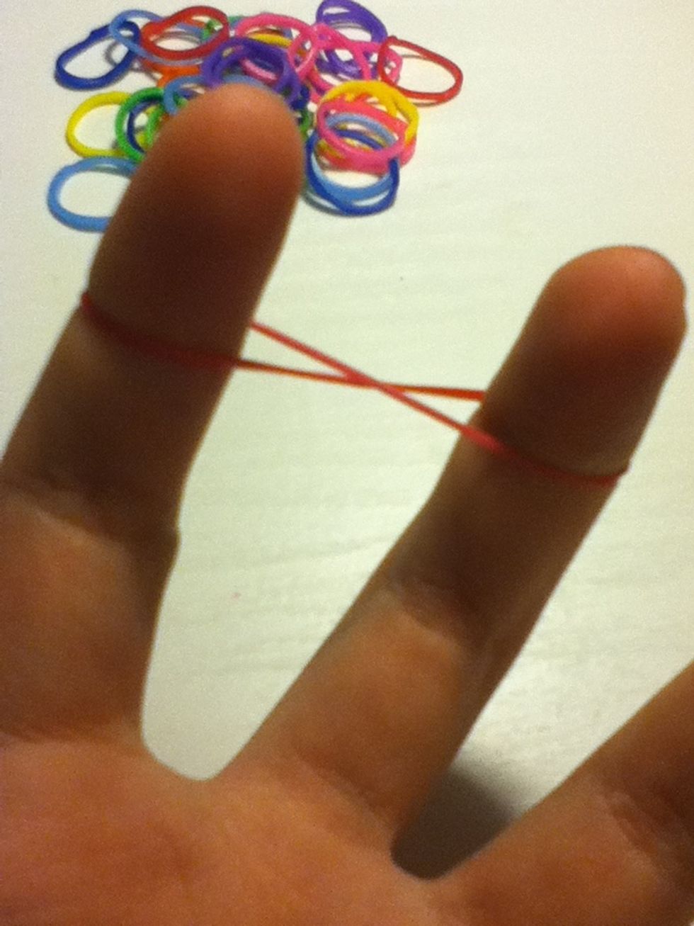 Get your first band and make a figure 8 around two of your fingers.