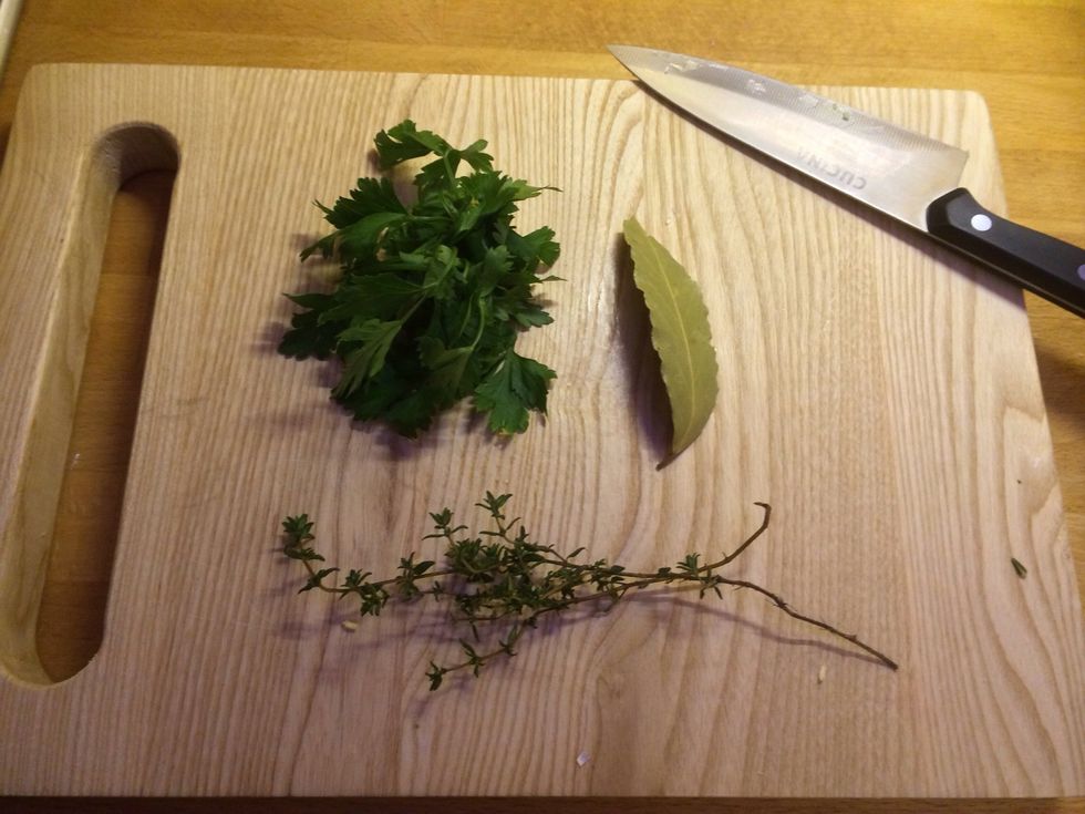 Get your herbs ready, take the leaves off of the steam of the thyme and chop with the parsley.