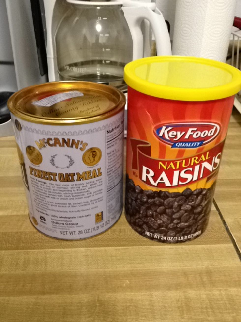 Get your oatmeal can and raisins out. Measure 1/4 cup, heaping, of oats and add to tall pan. Add 2 and 1/4 cups of water.