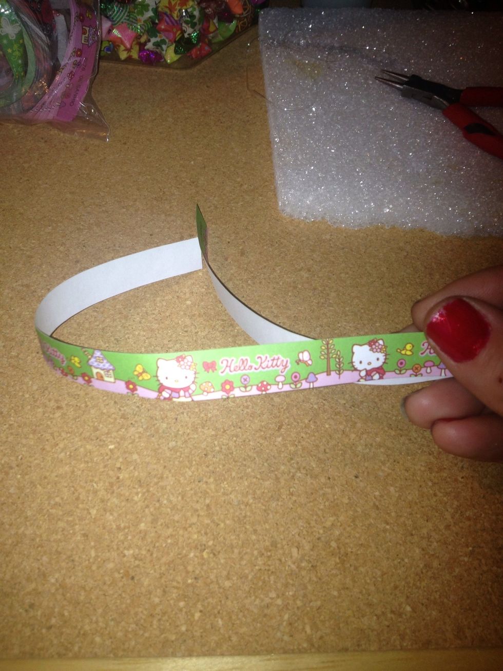 Get your piece of paper. You can cut out strips of paper and make your own design.