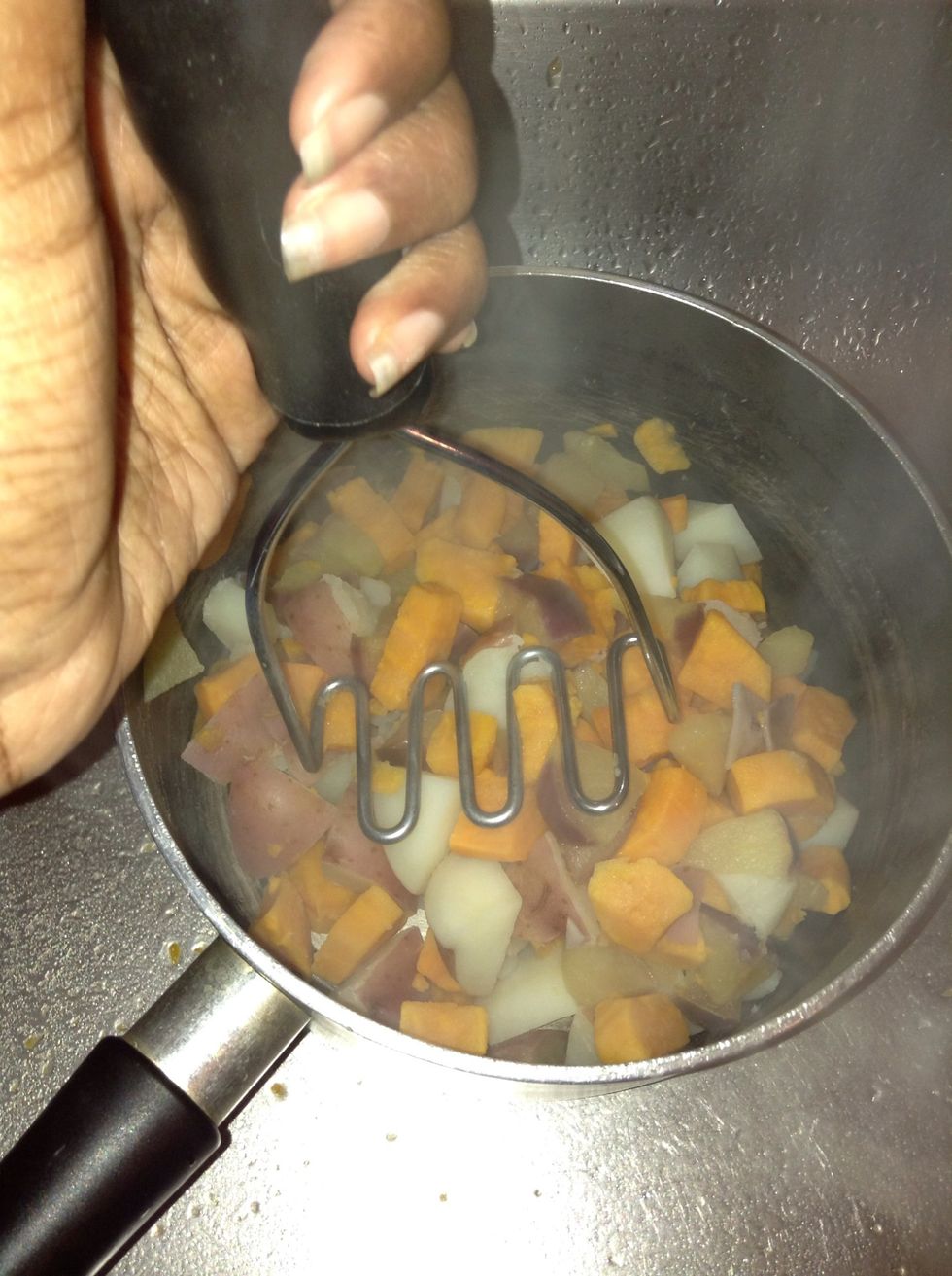 Get your potato masher and mash the potatoes up. I usually do it in the same pot that they were cooked in as the heat helps the cheese to melt plus it's less to clean up