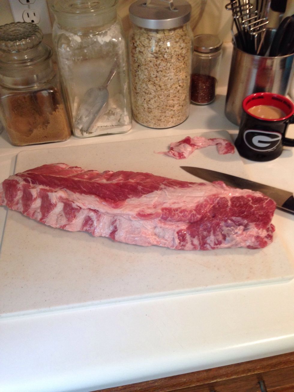 Get your ribs out and pat dry with paper towels. See the cup of coffee? I do the first few steps the morning of. That way the dry rub has time to set in. I also trim a little, but that's optional.