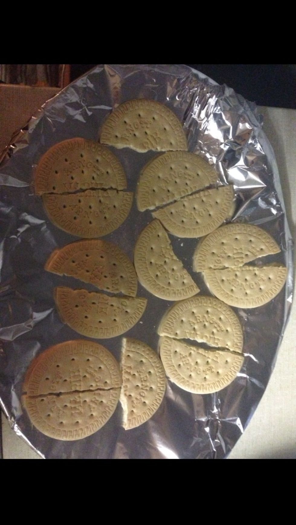 Get your round malted biscuits and cut them evenly in half.