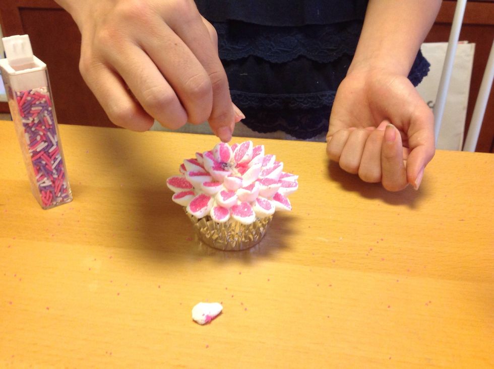 Get your sprinkles and sprinkle them in the center of the cupcake.