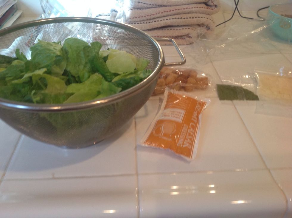 Get your supplies. Lettuce, dressing, croutons, and cheese