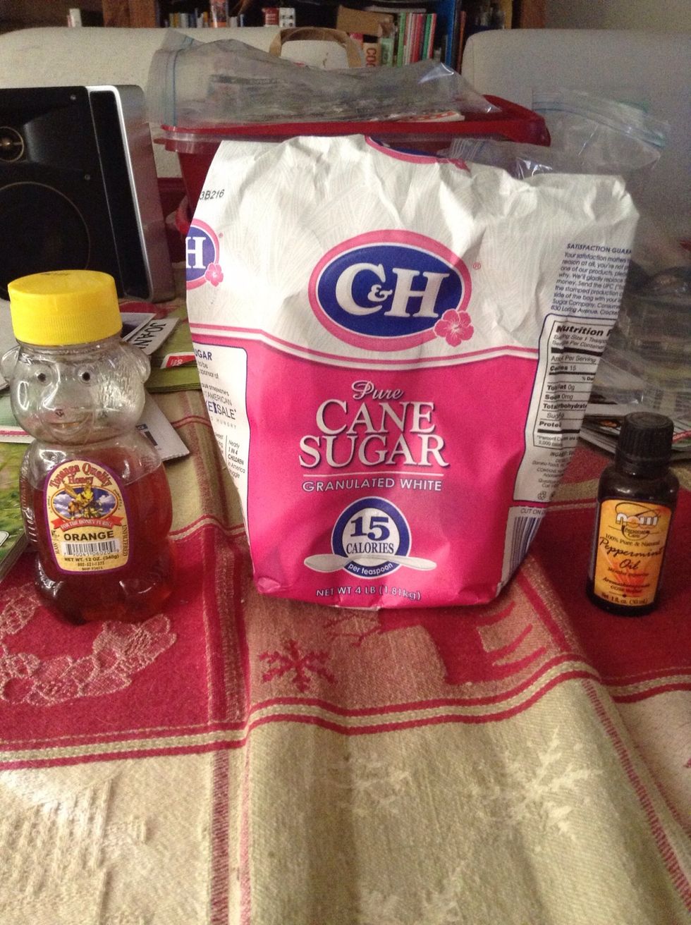 Get your supplies together: honey (I use orange honey), sugar, a teaspoon, and peppermint oil.