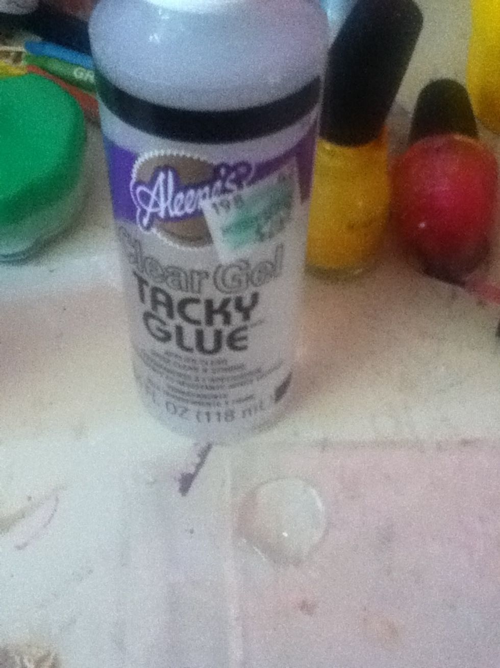 Get your tacky glue. Pour some on some plastic.