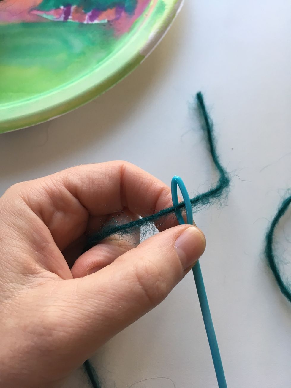 Get your yarn to weave. Put it through your needle eye.