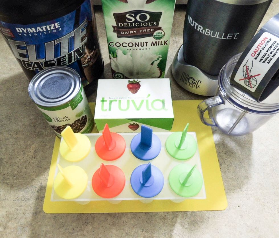 Getting ingredients and equipment ready: coconut milk, canned black beans, protein powder, popsicle tray and blender