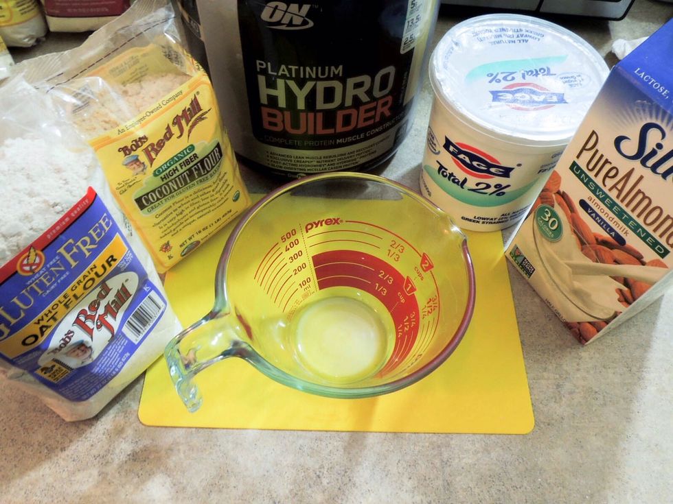 Getting ingredients for filling: oat flour, coconut flour, whey protein, greek yogurt, almond milk