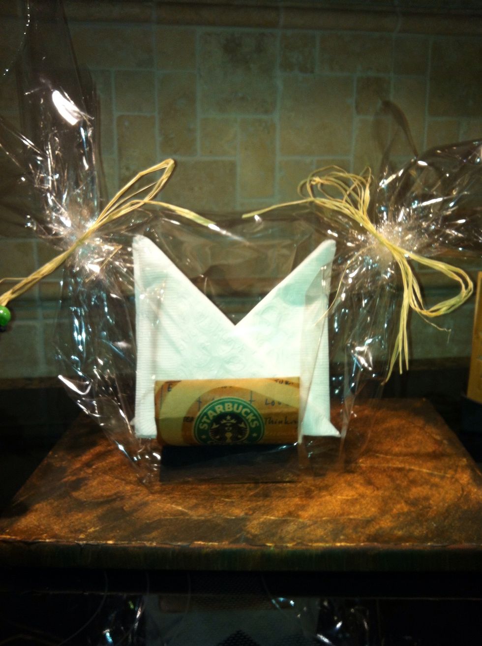 gift wrap the napkin holder and napkins in a clear wrap. Remember to fill up the napkins nice and tight to avoid spillage.