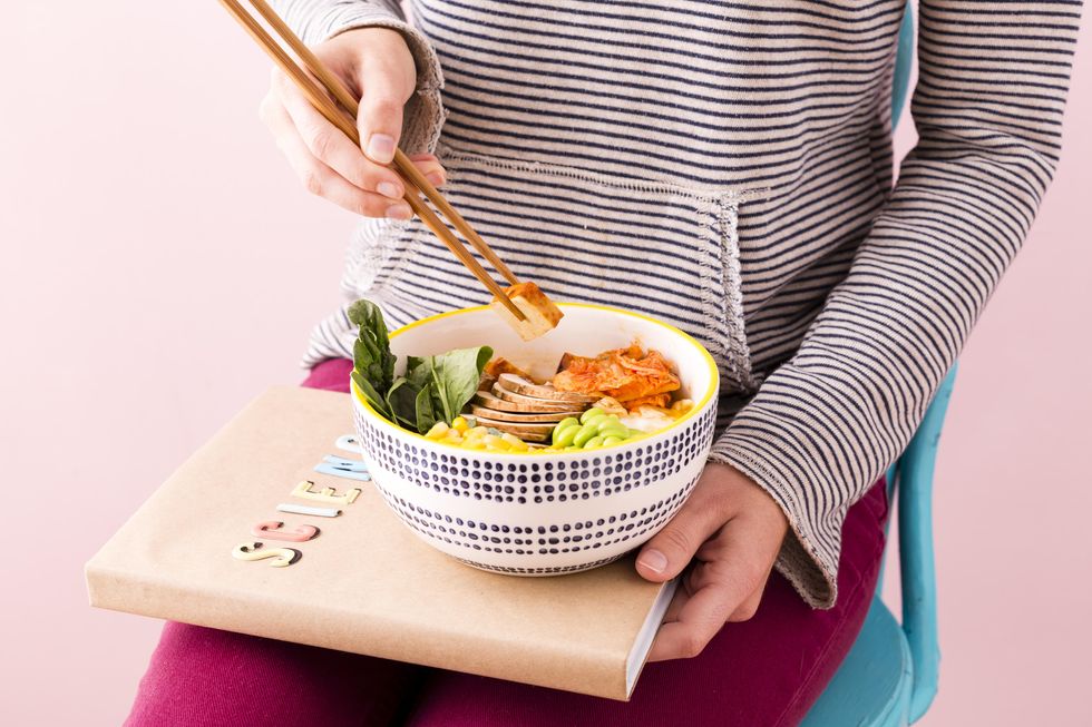 girl eating a tofu bowl