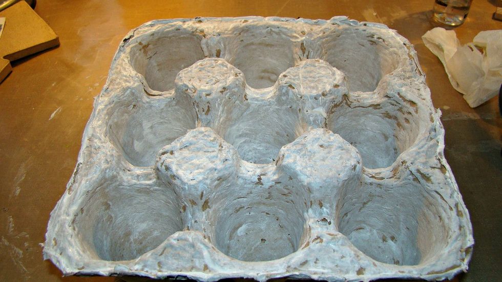 Give a coat of gesso to prime the surface for mediums.