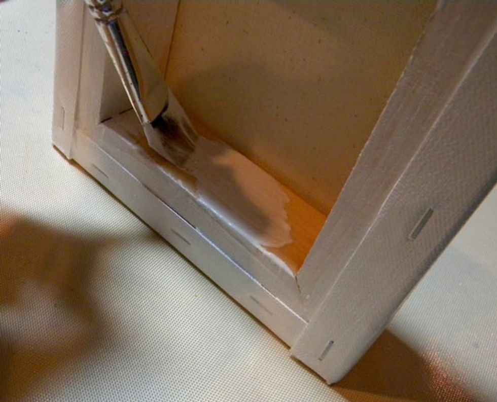 Give the back of the canvas a coat of gesso.