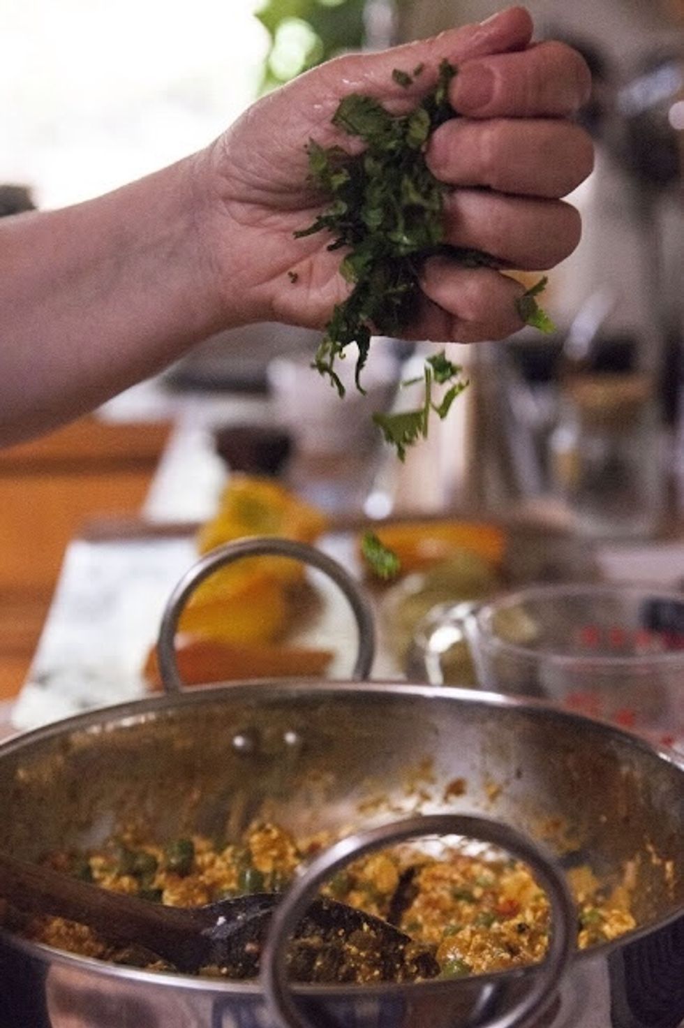 Give the dish a few grinds of black pepper, it's up to you. When Give it another 5 minutes or so on simmer. When the mixture is all heated through add in the chopped cilantro.