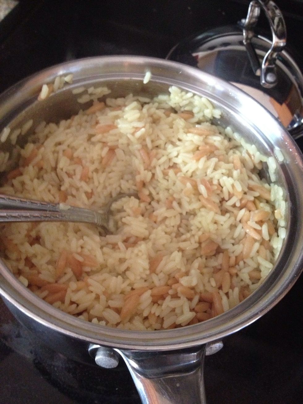Give the rice a stir ad you'll be ready to add it to the plate with the chicken. :)