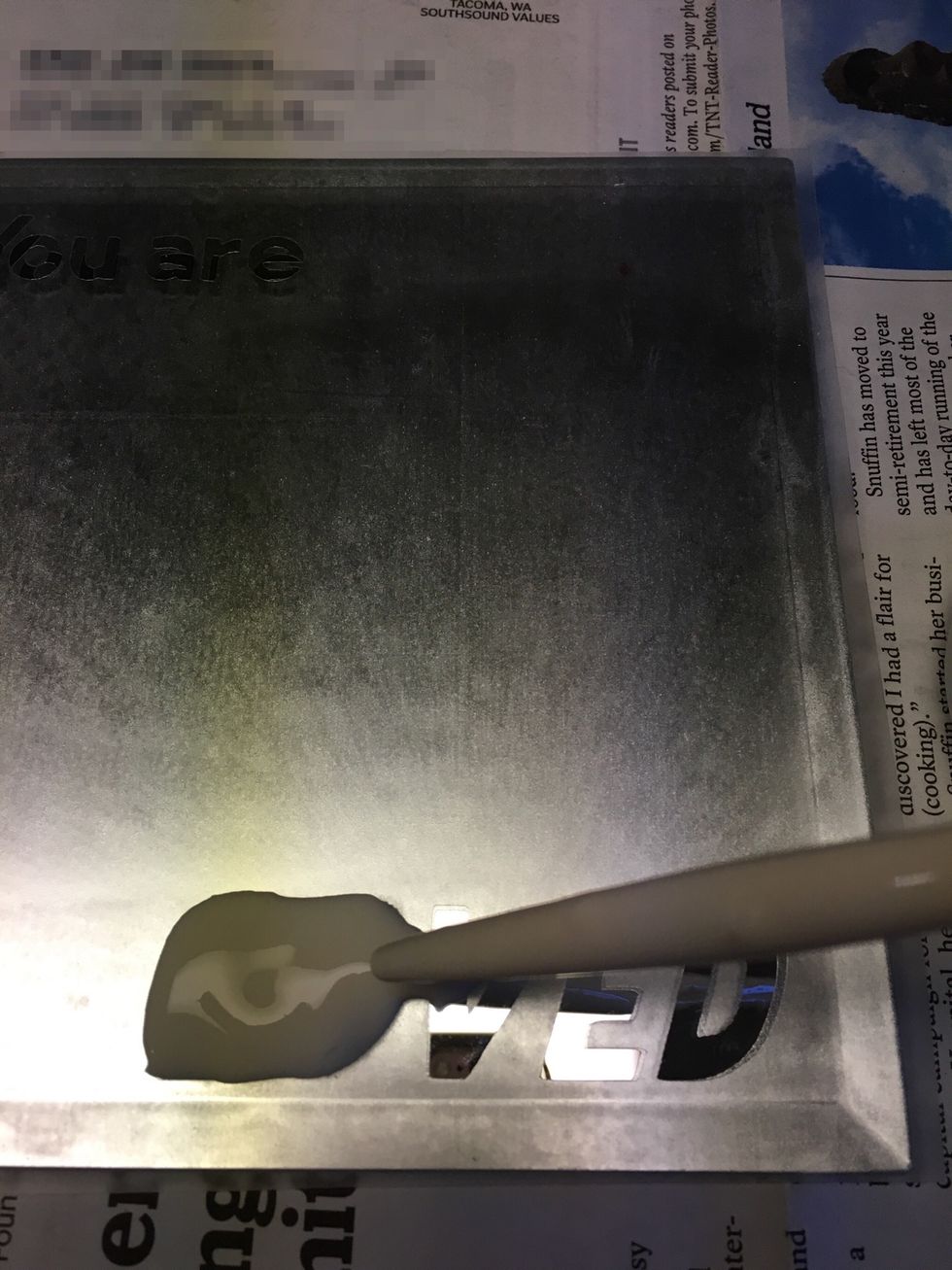 (Gloves are recommended for this step.) Use the wooden stick to spread the etching cream.