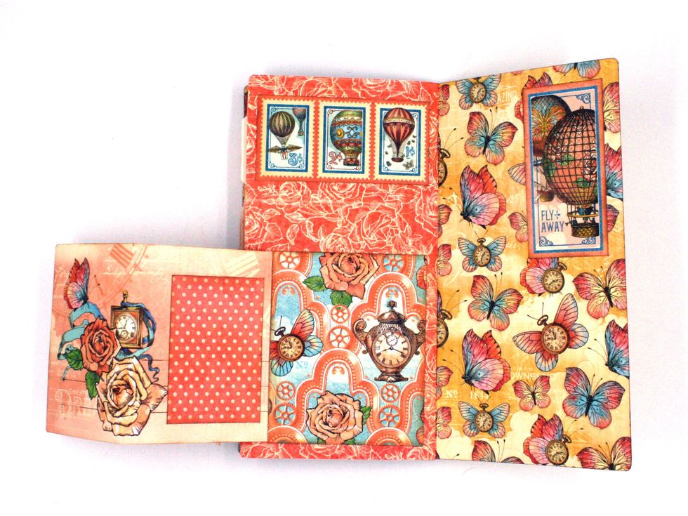 Glue 3 stamps at the top of the next page.  Score an ephemera card @ 1/2" & 3". Glue the 1/2 flap to the signature page so that the card folds out. Cover the glue strip w/ a 3 1/4 x 4" photo mat.