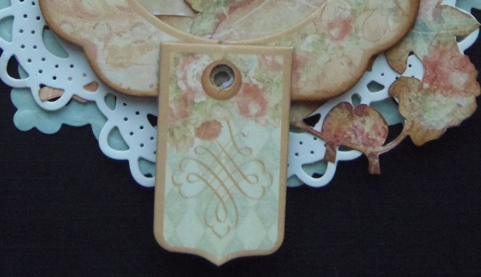 Glue a chipboard tab to the bottom-center of the chipboard frame. This chipboard tab will also serve as a pull down tab.