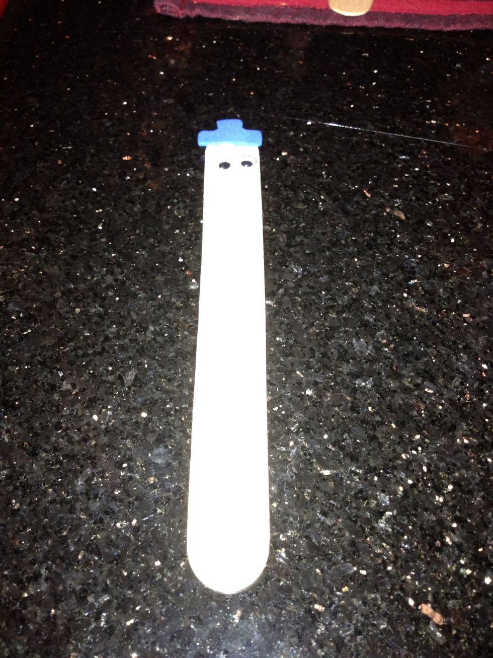 Glue a pair of google eyes onto the stick.