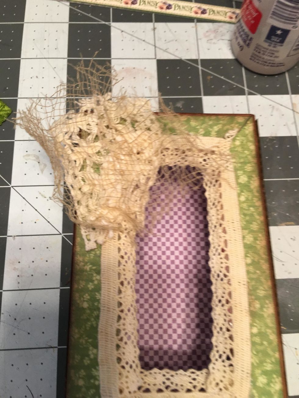 Glue a small piece of tea dyed gauze on top of the larger lace piece as shown.